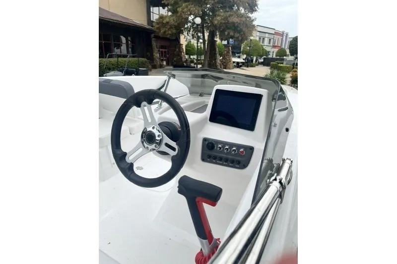 Slide: The Image of 2026 Tahoe T16 boat dashboard with steering wheel and control panel. - 7