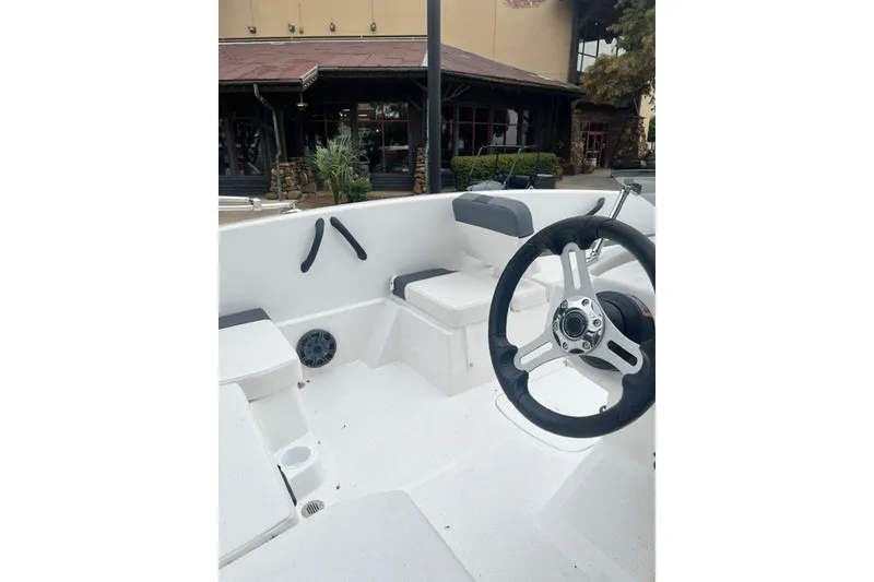 Slide: The Image of 2026 Tahoe T16 boat interior with steering wheel and seating area. - 6