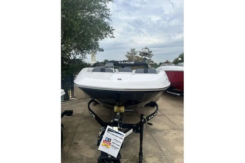 Slide: The Image of 2026 Tahoe T16 boat on trailer, displayed outdoors under cloudy sky. - 11