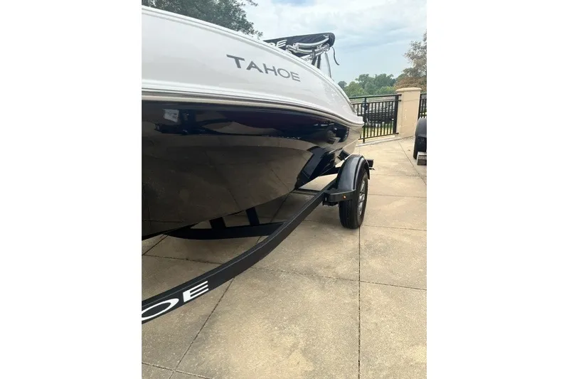 Slide: The Image of 2026 Tahoe T16 boat on trailer, parked outdoors on a paved surface. - 10