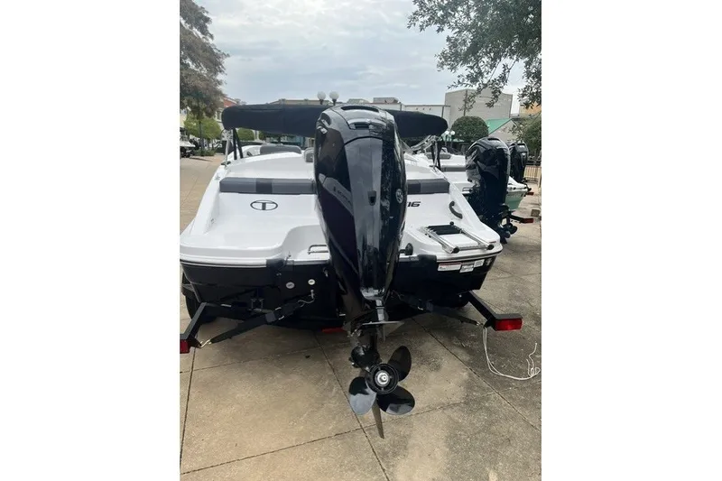 Slide: The Image of 2026 Tahoe T16 boat with outboard motor on a trailer, parked outdoors. - 4
