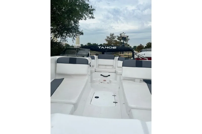 Slide: The Image of 2026 Tahoe T16 boat interior with white seating and overcast sky. - 8