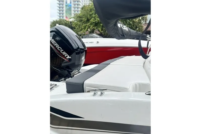 The Image of 2026 Tahoe T16 boat with Mercury engine, featuring sleek white and gray seating. - 0