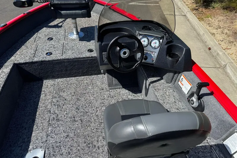 Slide: The Image of 2026 Tracker Pro Guide V-16 SC boat interior with steering console and seating. - 9