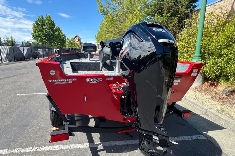 Slide: The Image of 2026 Tracker Pro Guide V-16 SC boat with Mercury 90 engine, parked outdoors. - 4