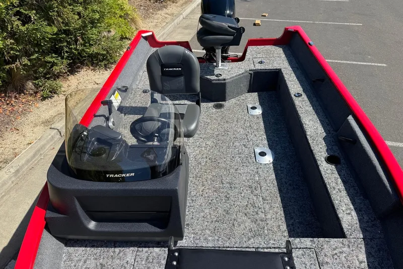 Slide: The Image of 2026 Tracker Pro Guide V-16 SC boat with red trim and gray interior. - 10