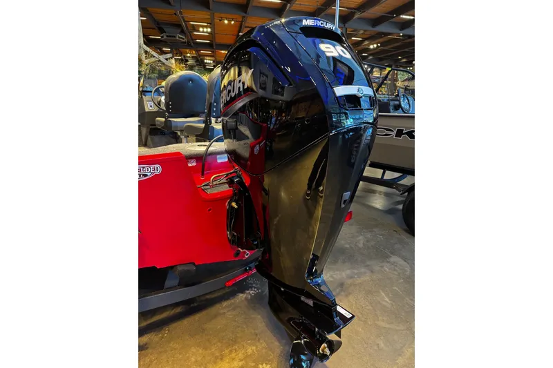 Slide: The Image of 2026 Tracker Pro Guide V-16 SC boat with Mercury 90 outboard motor in showroom. - 3