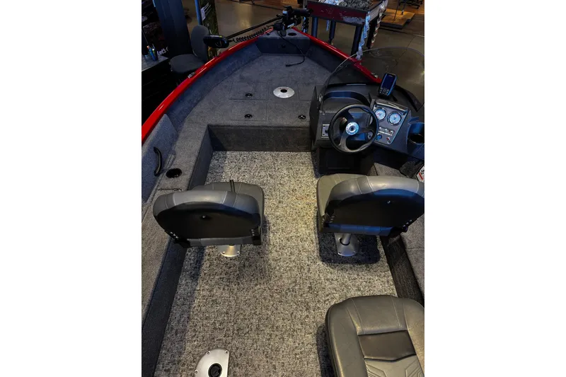 Slide: The Image of 2026 Tracker Pro Guide V-16 SC boat interior with steering console and seating. - 5
