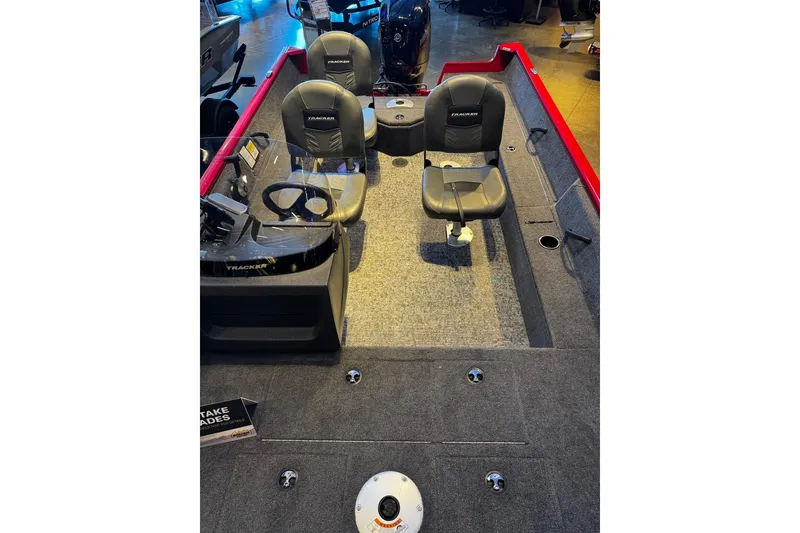 Slide: The Image of 2026 Tracker Pro Guide V-16 SC boat interior with seating and steering console. - 4