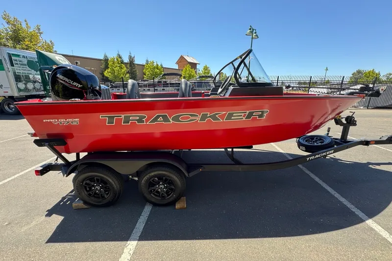 Slide: The Image of 2026 Tracker Pro Guide V-175 WT boat on trailer, vibrant red color, parked outdoors. - 3