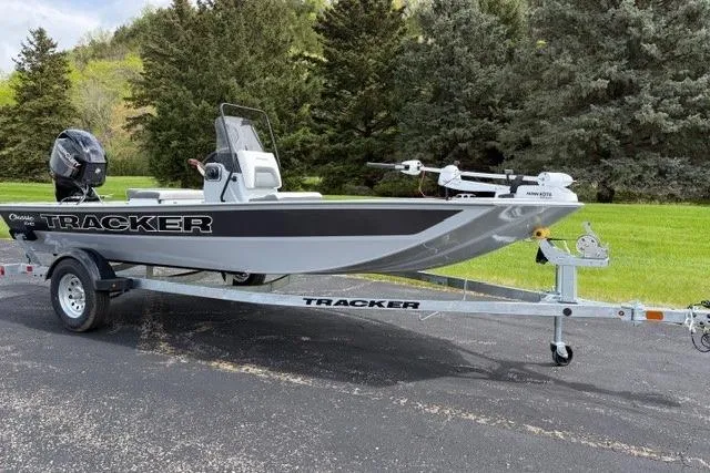 The Image of 2026 Tracker Bass Tracker Classic CC boat on trailer, parked outdoors. - 0