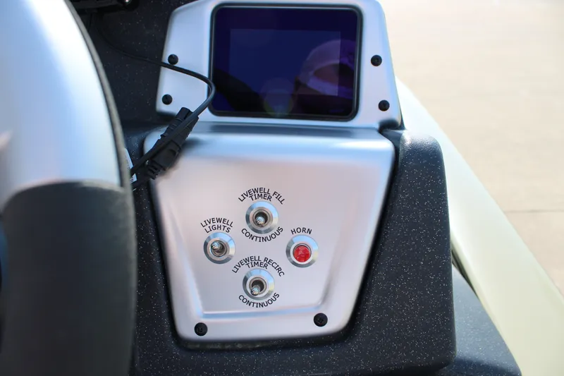 Slide: The Image of Control panel of 2026 Tracker Pro Team 195 boat with switches and display screen. - 65