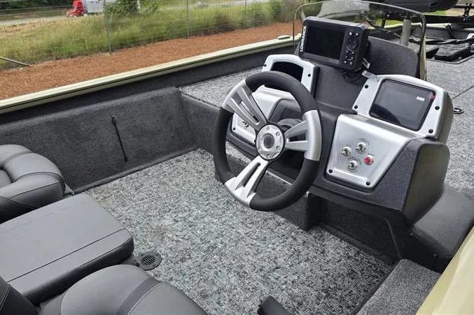 Slide: The Image of 2026 Tracker Pro Team 190 boat interior with modern steering and dashboard controls. - 4