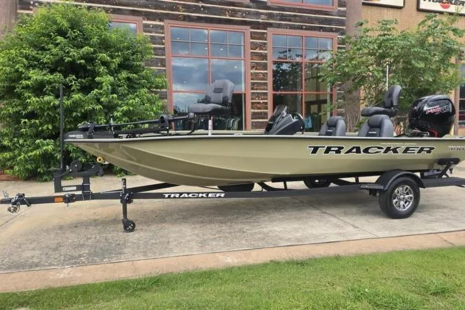 The Image of 2026 Tracker Pro Team 190 boat on trailer, parked outdoors near a building. - 0
