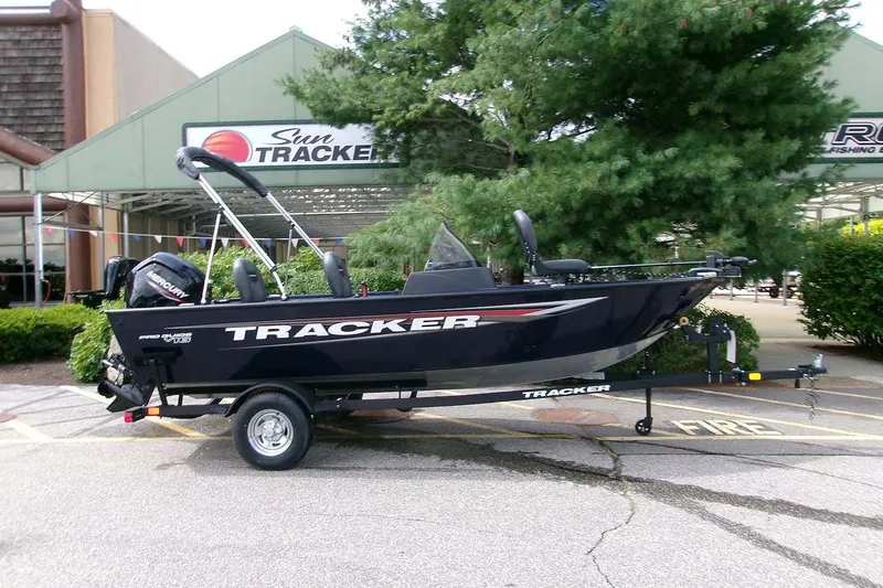 The Image of 2026 Tracker Pro Guide V-16 SC boat on trailer outside dealership. - 0