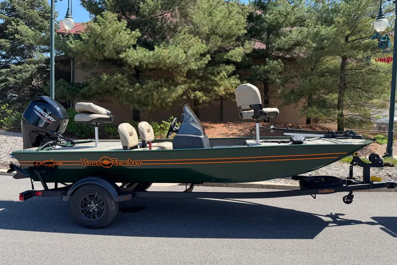 The Image of 2026 Tracker Bass Tracker Classic Limited fishing boat on trailer, parked outdoors. - 0