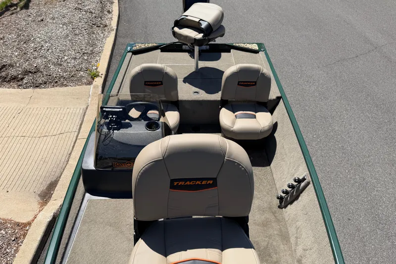 Slide: The Image of 2026 Tracker Bass Tracker Classic Limited boat interior with beige seats and steering console. - 4