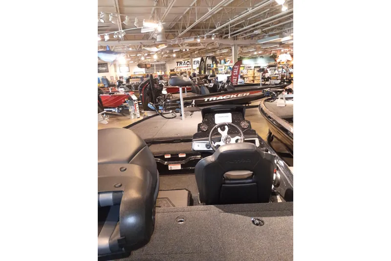 Slide: The Image of 2026 Nitro Z20 XL boat interior at dealership, featuring steering wheel and seating. - 3