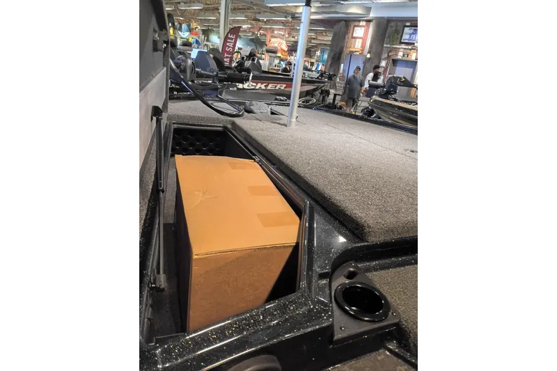 Slide: The Image of 2026 Nitro Z20 XL boat storage compartment with a cardboard box inside. - 9