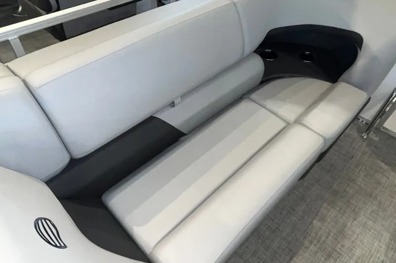 Slide: The Image of 2026 Sun Tracker Party Barge 20 DLX interior seating with cup holders, featuring sleek gray upholstery. - 23
