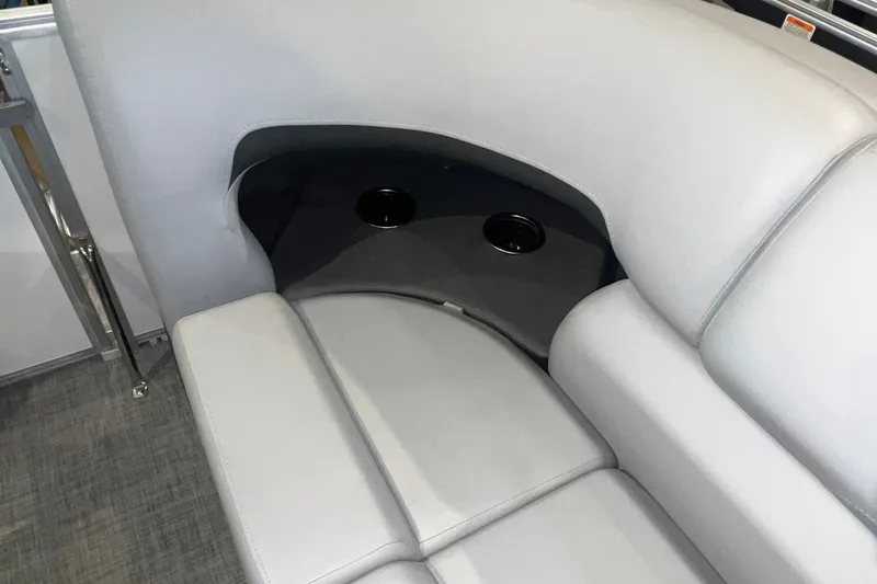 Slide: The Image of 2026 Sun Tracker Party Barge 20 DLX interior with cushioned seating and cup holders. - 28