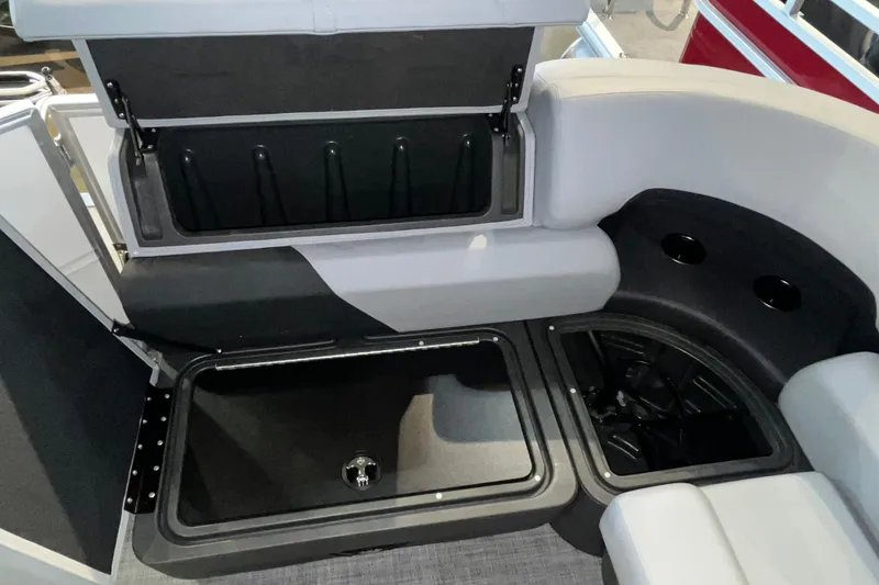 Slide: The Image of 2026 Sun Tracker Party Barge 20 DLX interior storage compartments and seating area. - 20