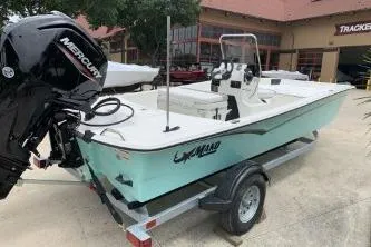 Slide: The Image of 2026 Mako Pro Skiff 17 CC boat with Mercury engine on trailer. - 4