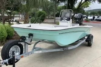 Slide: The Image of 2026 Mako Pro Skiff 17 CC boat on trailer, parked outdoors. - 8