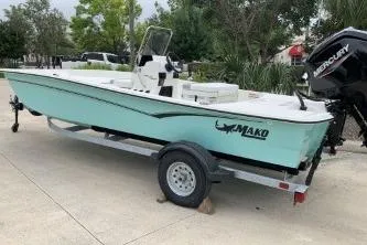 Slide: The Image of 2026 Mako Pro Skiff 17 CC boat on trailer, parked outdoors. - 2