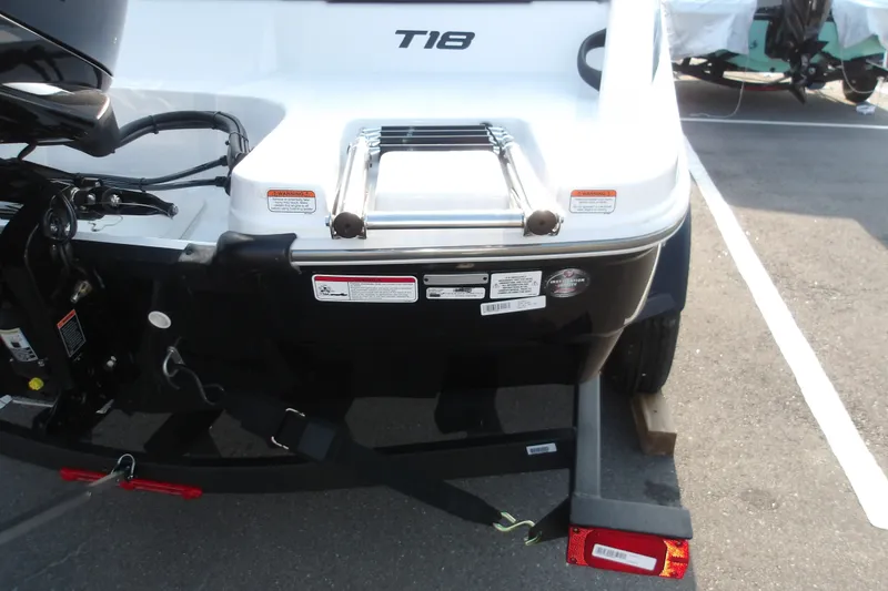 Slide: The Image of 2026 Tahoe T18 boat rear view with ladder and trailer attachment. - 5