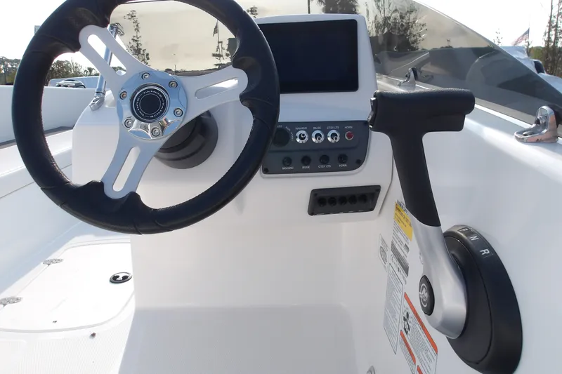 Slide: The Image of Steering console of 2026 Tahoe T18 boat with controls and display screen. - 14