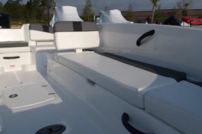 Slide: The Image of 2026 Tahoe T18 boat interior with white seating and storage compartments. - 16