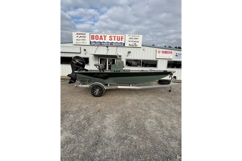 The Image of 2026 Avid 18 Rogue CC boat on trailer outside dealership, featuring Yamaha outboard motor. - 1