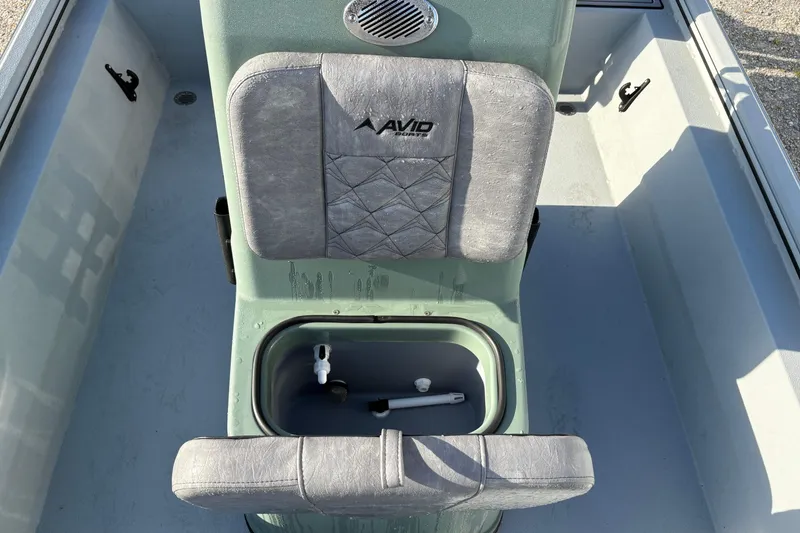 Slide: The Image of Interior view of 2026 Avid 18 Rogue CC boat seat with storage compartment. - 12