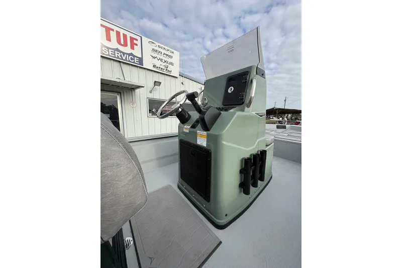 Slide: The Image of 2026 Avid 18 Rogue CC boat with sleek deck design, parked outside a building. - 8