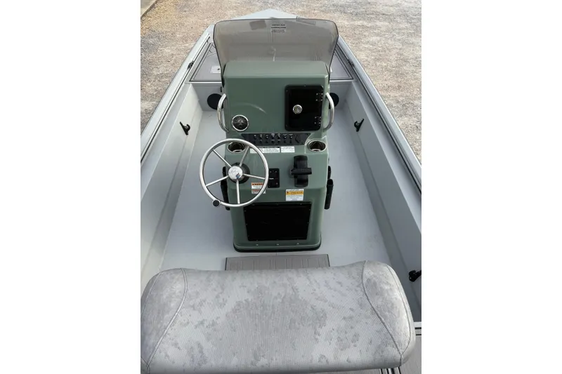 Slide: The Image of 2026 Avid 18 Rogue CC boat interior with steering console and seating. - 9