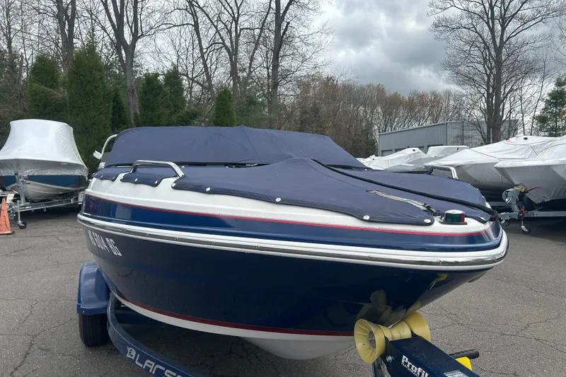 Slide: The Image of 2017 Larson LX 185S I/O boat with cover, parked outdoors on trailer. - 10