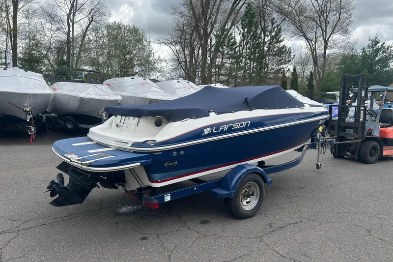 Slide: The Image of 2017 Larson LX 185S I/O boat on trailer, covered, parked outdoors. - 13