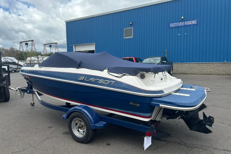 Slide: The Image of 2017 Larson LX 185S I/O boat with cover in parking lot. - 14