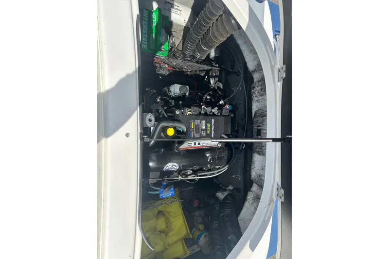 Slide: The Image of Engine compartment of a 2017 Larson LX 185S I/O boat, showcasing mechanical components. - 15