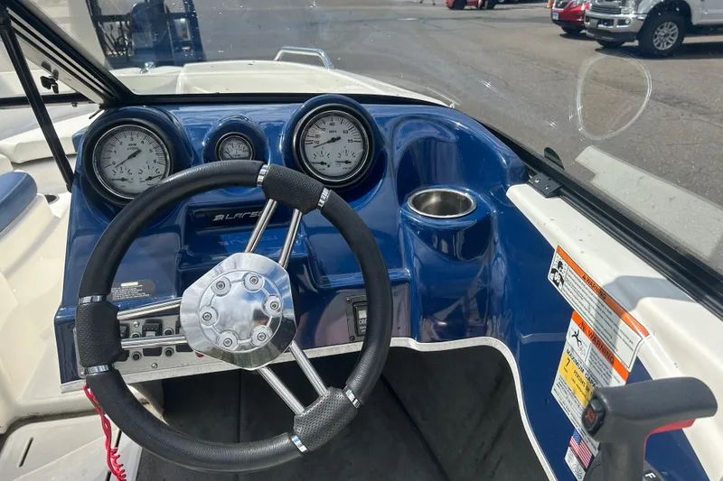 Slide: The Image of Steering wheel and dashboard of a 2017 Larson LX 185S I/O boat. - 16