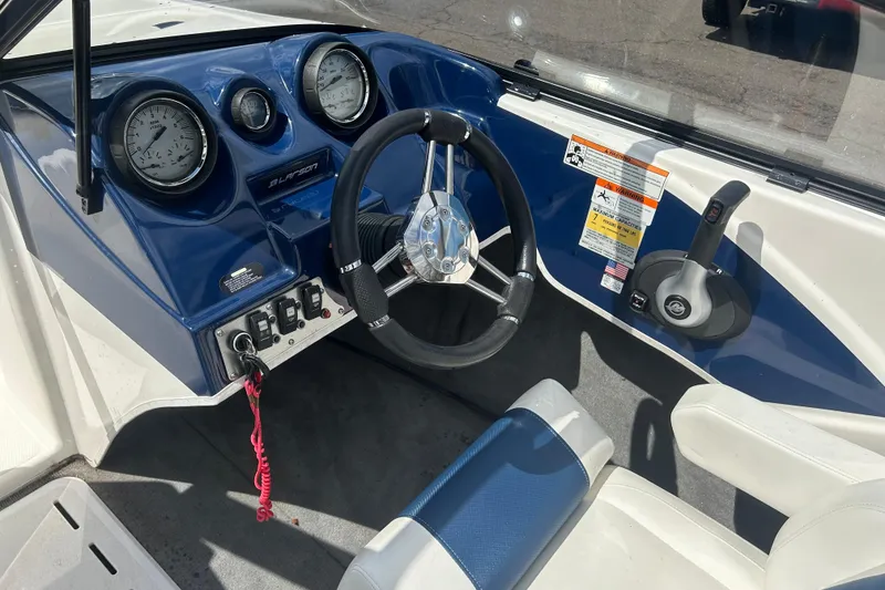 Slide: The Image of 2017 Larson LX 185S I/O boat dashboard with steering wheel and gauges. - 17