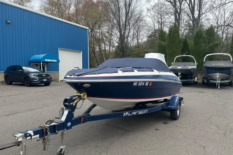 Slide: The Image of 2017 Larson LX 185S I/O boat on trailer, parked outside dealership. - 9