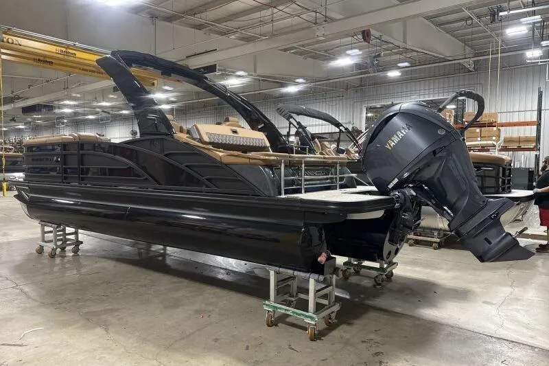 The Image of 2026 Bennington R 23 RSBA pontoon boat with Yamaha engine in a warehouse. - 1