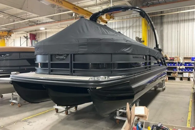 Slide: The Image of 2026 Bennington R 23 RSBA pontoon boat in a warehouse, covered and elevated. - 13