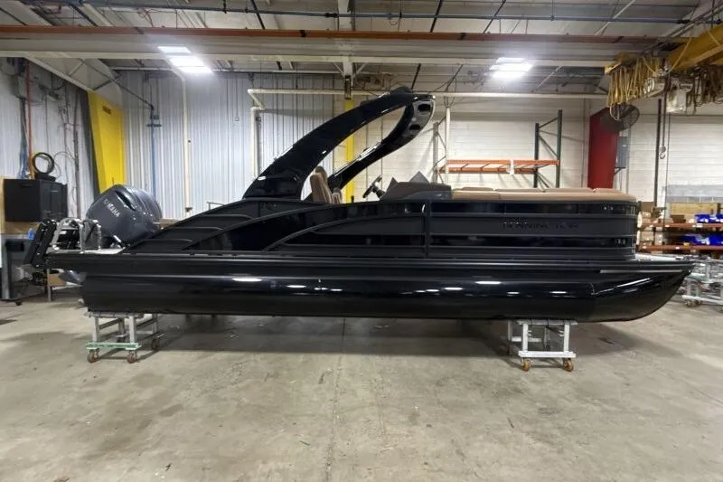 Slide: The Image of 2026 Bennington R 23 RSBA pontoon boat in a warehouse setting. - 4