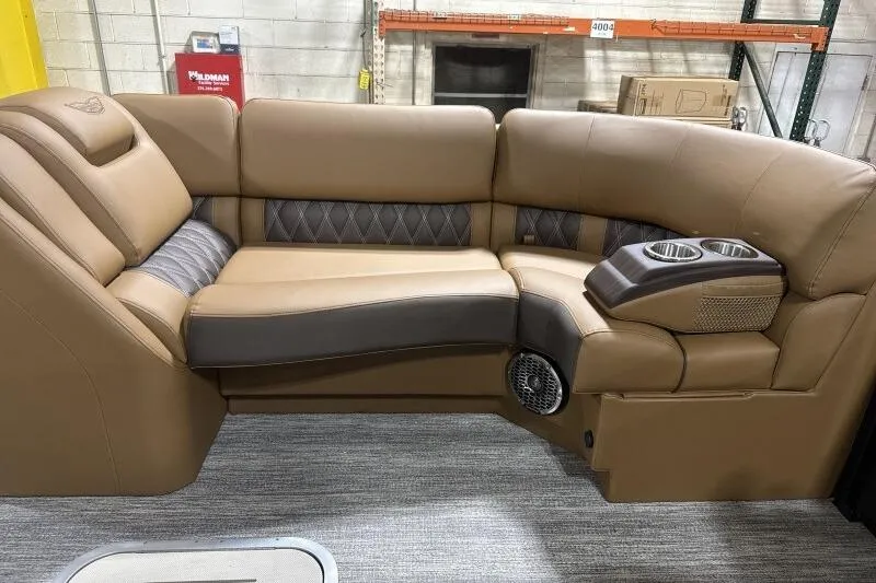 Slide: The Image of 2026 Bennington R 23 RSBA boat seating with tan leather upholstery and cup holders. - 7