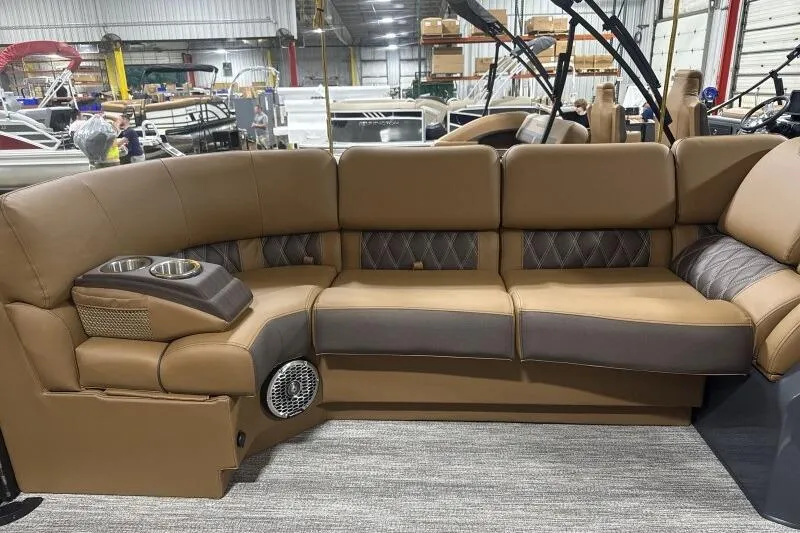 Slide: The Image of Luxurious seating on 2026 Bennington R 23 RSBA pontoon boat, featuring cup holders and speaker. - 8