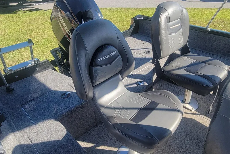 Slide: The Image of 2020 Tracker Pro Guide V-16 SC boat interior with black seats and Mercury engine. - 10