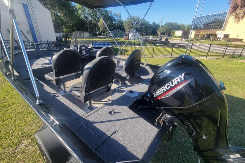 Slide: The Image of 2020 Tracker Pro Guide V-16 SC boat with Mercury engine, parked on grass. - 11